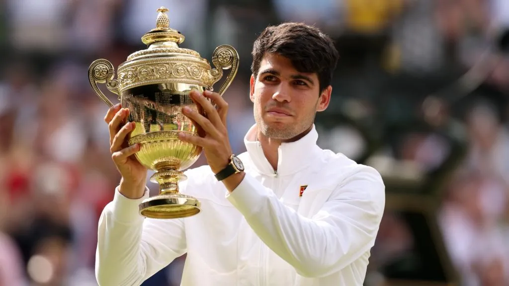Carlos Alcaraz of Spain poses with the Gentlemen’s Singles Trophy in the Gentlemen’s Singles Final during day fourteen of The Championships Wimbledon 2024. (Source: Julian Finney/Getty Images)
