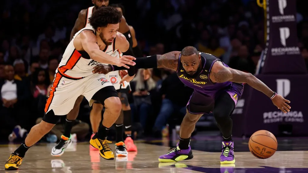 Cade Cunningham #2 of the Detroit Pistons and LeBron James #23 of the Los Angeles Lakers go for the loose ball in the first half at Crypto.com Arena. (Ronald Martinez/Getty Images)