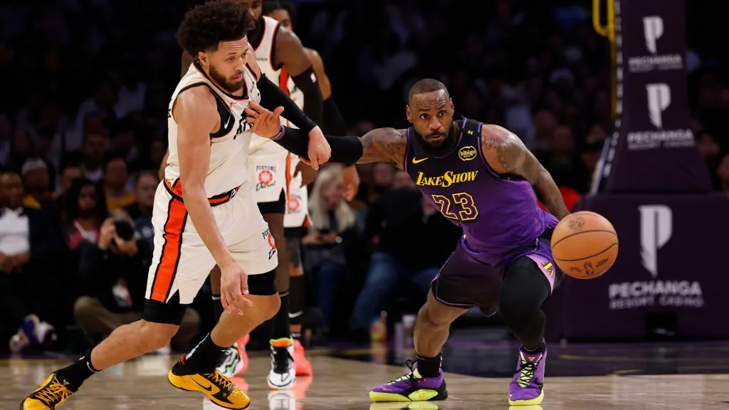 Cade Cunningham #2 of the Detroit Pistons and LeBron James #23 of the Los Angeles Lakers go for the loose ball in the first half at Crypto.com. (Ronald Martinez/Getty Images)