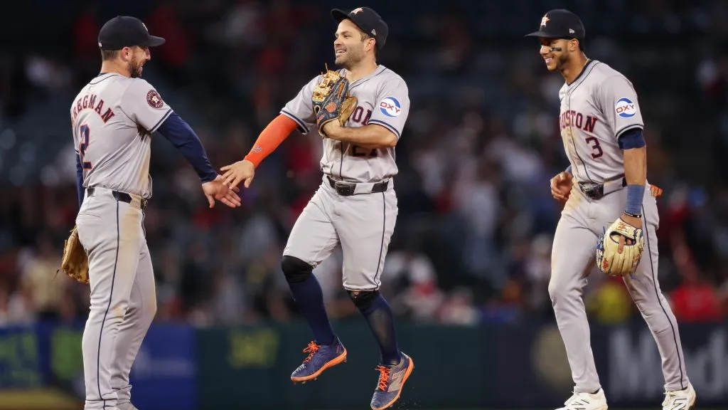 Alex Bregman #2, Jose Altuve #27, and Jeremy Peña #3 of the Houston Astros celebrate after defeating the Los Angeles Angels at Angel Stadium of Anaheim on September 14, 2024 in Anaheim, California. (Photo by Meg Oliphant/Getty Images)