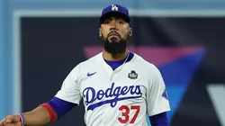 Teoscar Hernández #37 of the Los Angeles Dodgers removes debris from the field as they play the New York Yankees in the fifth inning during Game Two of the 2024 World Series at Dodger Stadium on October 26, 2024 in Los Angeles, California.