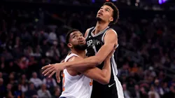Karl-Anthony Towns #32 of the New York Knicks and Victor Wembanyama #1 of the San Antonio Spurs battle for a rebound during the first quarter at Madison Square Garden.