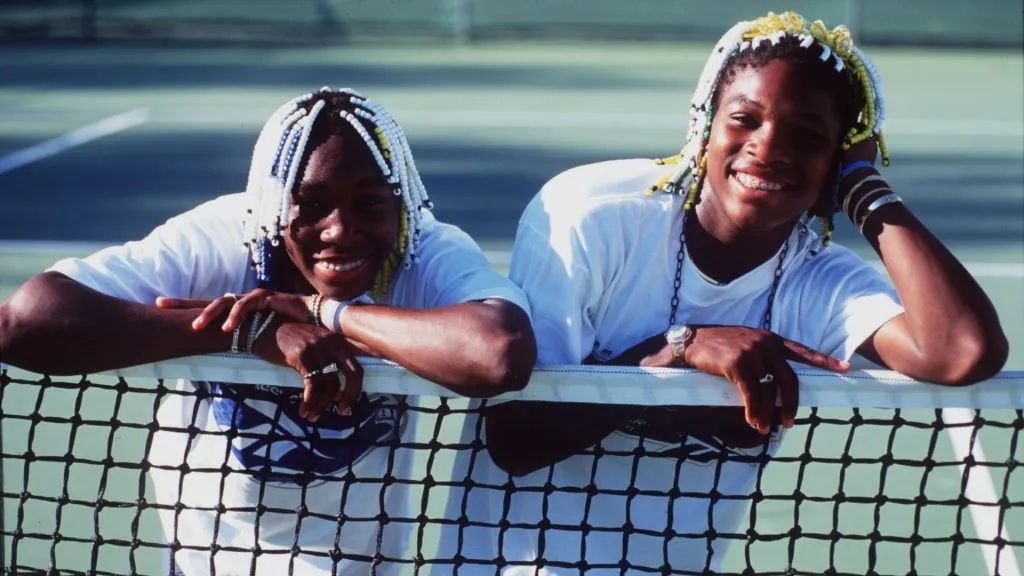 Teenage tennis sisters from America, Venus (left) and Serena Williams take time off a practise session to pose together during the Adidas International event on 16 Jan 1998. (Source: Clive Brunskill/Allsport)