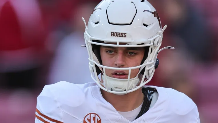 Arch Manning 16 Longhorn QB takes a snap from his center. Texas defeated Arkansas 20-10 in Fayetteville, AR.