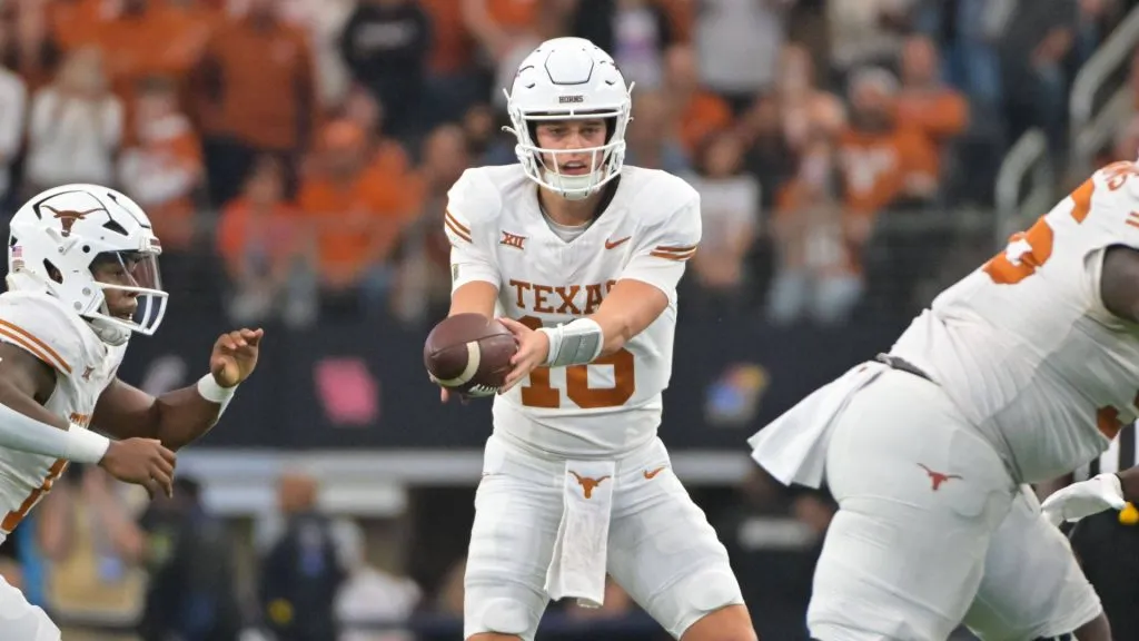 Texas Longhorns quarterback Arch Manning (16) gets ready to hand the ball off during the 2nd half of the NCAA Football game between the Oklahoma State Cowboys and Texas Longhorns at AT&amp;T Stadium in Arlington, Texas.