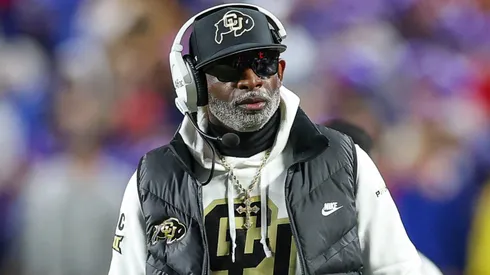 Colorado Buffaloes head coach Deion Sanders walks the field during the two minute warning time out against the Kansas Jayhawks at GEHA Field at Arrowhead Stadium in Kansas City, MO.