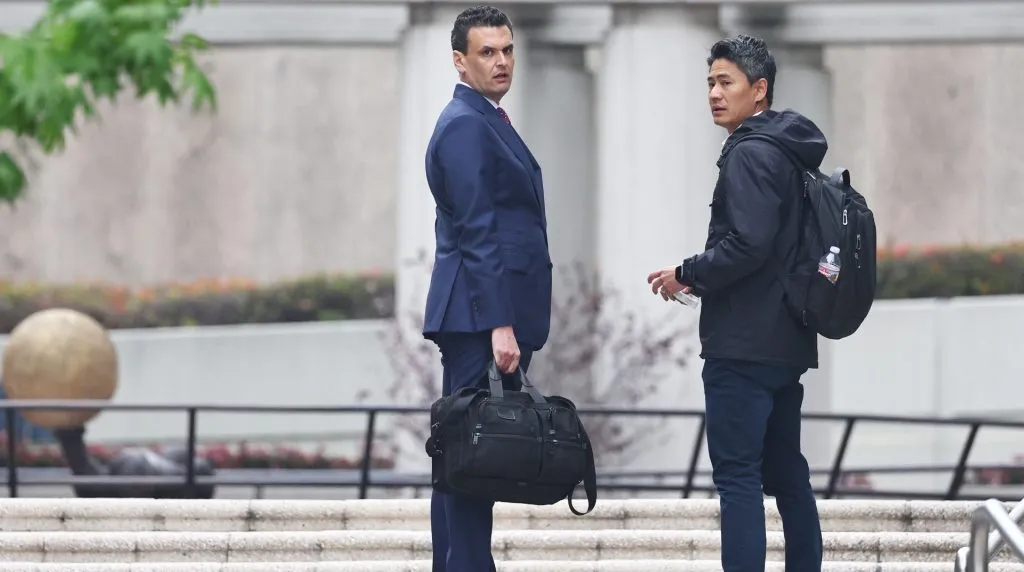 Attorney Michael G. Freedman (C), who is is representing Ippei Mizuhara, the former translator for Los Angeles Dodgers baseball star Shohei Ohtani, stands before entering court for Mizuhara’s appearance on federal bank fraud charges on April 12, 2024 in Los Angeles, California. Mizuhara allegedly stole over $16 million from Ohtani to settle illegal gambling debts. (Photo by Mario Tama/Getty Images)