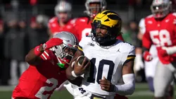 Alex Orji #10 of the Michigan Wolverines is tackled by Caleb Downs #2 of the Ohio State Buckeyes during the first quarter at Ohio Stadium on November 30, 2024 in Columbus, Ohio.
