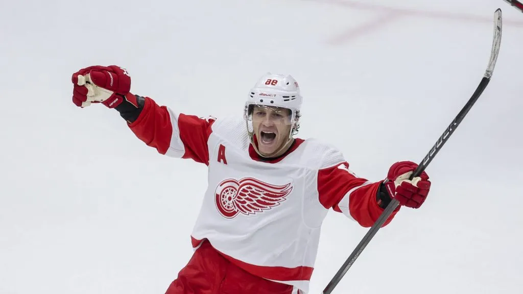Detroit Red Wings right wing Patrick Kane (88) celebrates after scoring the game-winning goal past Chicago Blackhawks goaltender Petr Mrazek (34) in overtime at the United Center Sunday, Feb. 25, 2024, in Chicago.