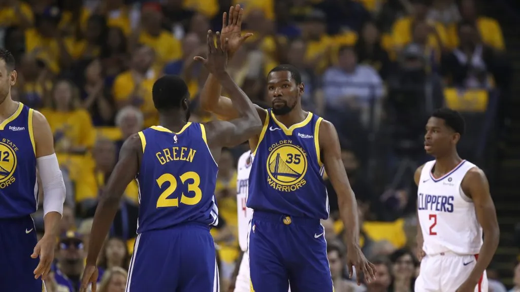 Kevin Durant #35 of the Golden State Warriors high-fives Draymond Green #23 of the Golden State Warriors during their game against the LA Clippers. (Ezra Shaw/Getty Images)
