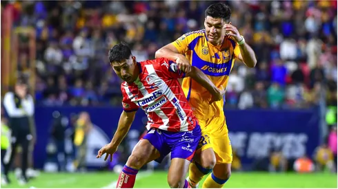 Ricardo Chavas (L) of San Luis fights for the ball with Jesus Angulo (R) of Tigres