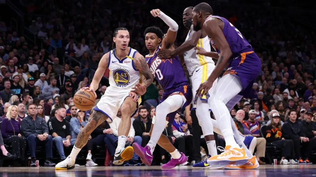 Lindy Waters III #43 of the Golden State Warriors dribbles around a screen set by Draymond Green #23 and Ryan Dunn #0 of the Phoenix Suns during the second half at Footprint Center. (Chris Coduto/Getty Images)