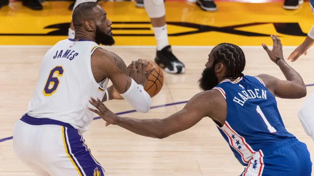 LeBron James 6 of the Los Angeles Lakers is defended by James Harden 1 of the Philadelphia 76ers.