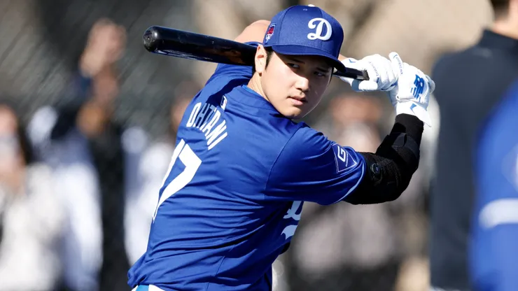 Shohei Ohtani #17 of the Los Angeles Dodgers swings the bat during workouts at Camelback Ranch on February 14, 2024.