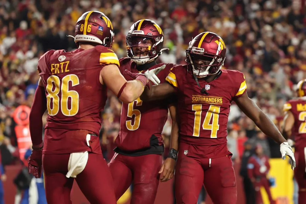 LANDOVER, MARYLAND – DECEMBER 29: Zach Ertz #86, Jayden Daniels #5, and Olamide Zaccheaus #14 of the Washington Commanders celebrate after Ertz scored a touchdown in the third quarter against the Atlanta Falcons at Northwest Stadium on December 29, 2024 in Landover, Maryland. (Photo by Scott Taetsch/Getty Images)