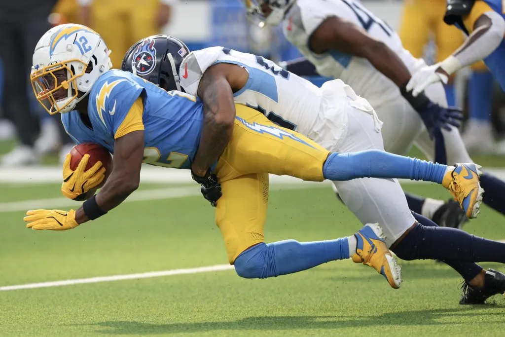  Tre Avery #23 of the Tennessee Titans tackles Derius Davis #12 of the Los Angeles Chargers