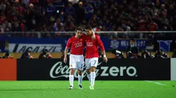 Cristiano Ronaldo and Gary Neville talking in a Manchester United match.
