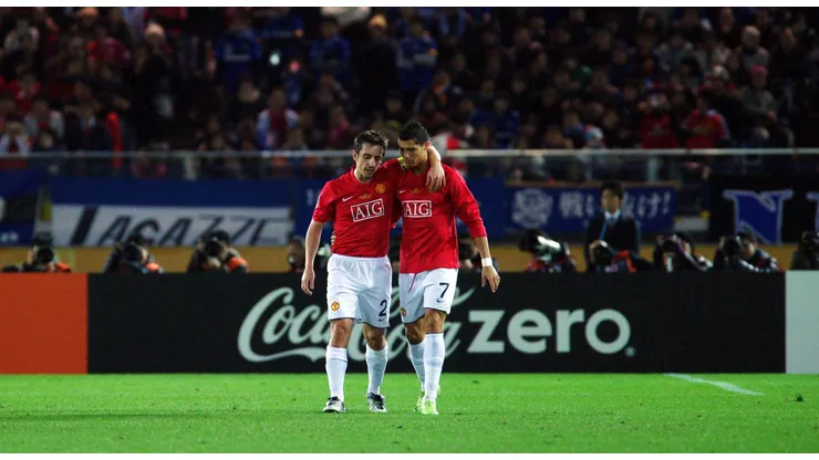 Cristiano Ronaldo and Gary Neville talking in a Manchester United match.
