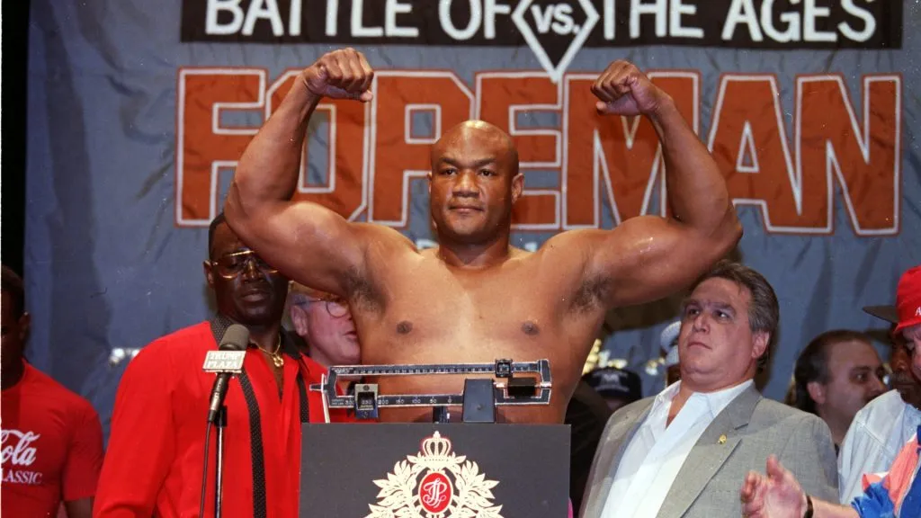 George Foreman raises his arms as he weighs in before the fight against Evander Holyfield at the Trump Plaza in Atlantic City, New Jersey. Mandatory Credit: Rick Stewart /Allsport