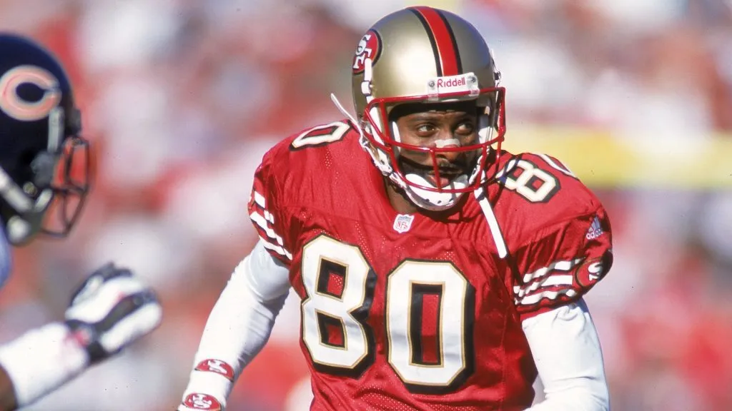 Jerry Rice #80 of the San Francisco 49ers looks to the side while running during the game against the Chicago Bears in 2000. (Source: Jed Jacobsohn /Allsport)