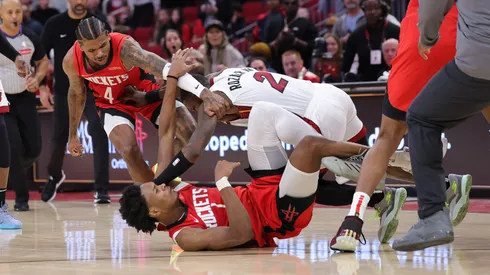 Jalen Green #4 and Amen Thompson #1 of the Houston Rockets fight with Terry Rozier #2 of the Miami Heat during the second half at Toyota Center on December 29, 2024 in Houston, Texas.