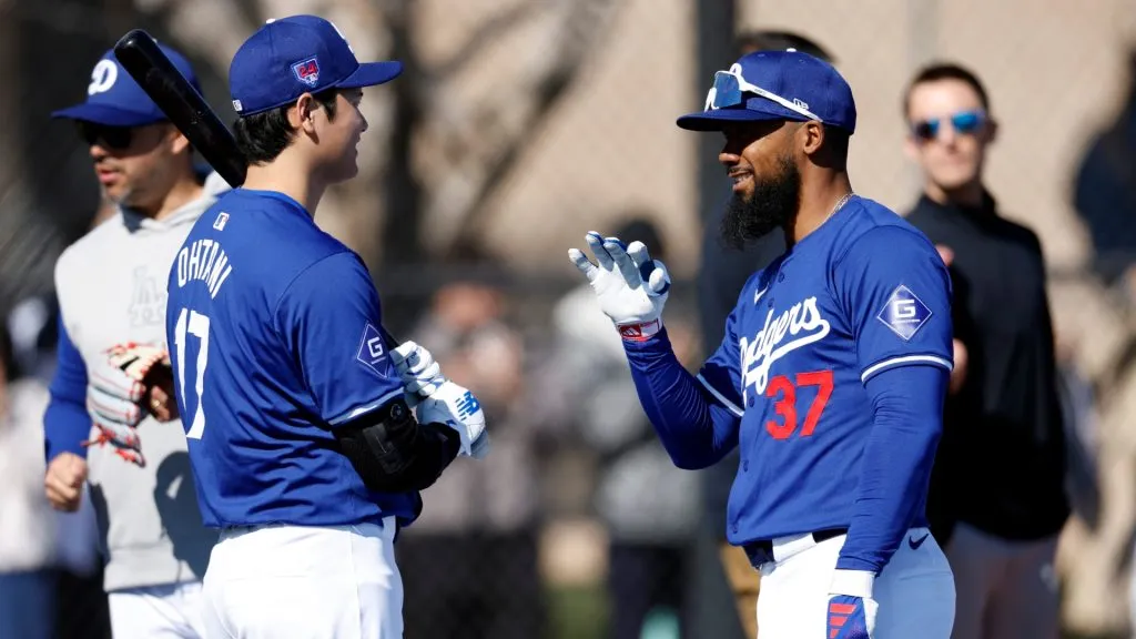 Shohei Ohtani #17 of the Los Angeles Dodgers talks with Teoscar Hernández #37 during workouts at Camelback Ranch on February 14, 2024 in Glendale, Arizona. (Photo by Chris Coduto/Getty Images)