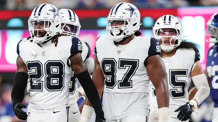 Malik Hooker #28 and Osa Odighizuwa #97 of the Dallas Cowboys
