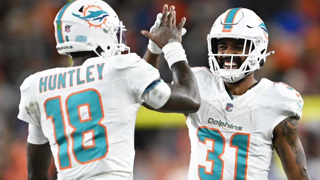 Tyler Huntley #18 of the Miami Dolphins celebrates a touchdown with Raheem Mostert #31 during the third quarter against the Cleveland Browns at Huntington Bank Field on December 29, 2024. (Source: Nick Cammett/Getty Images)