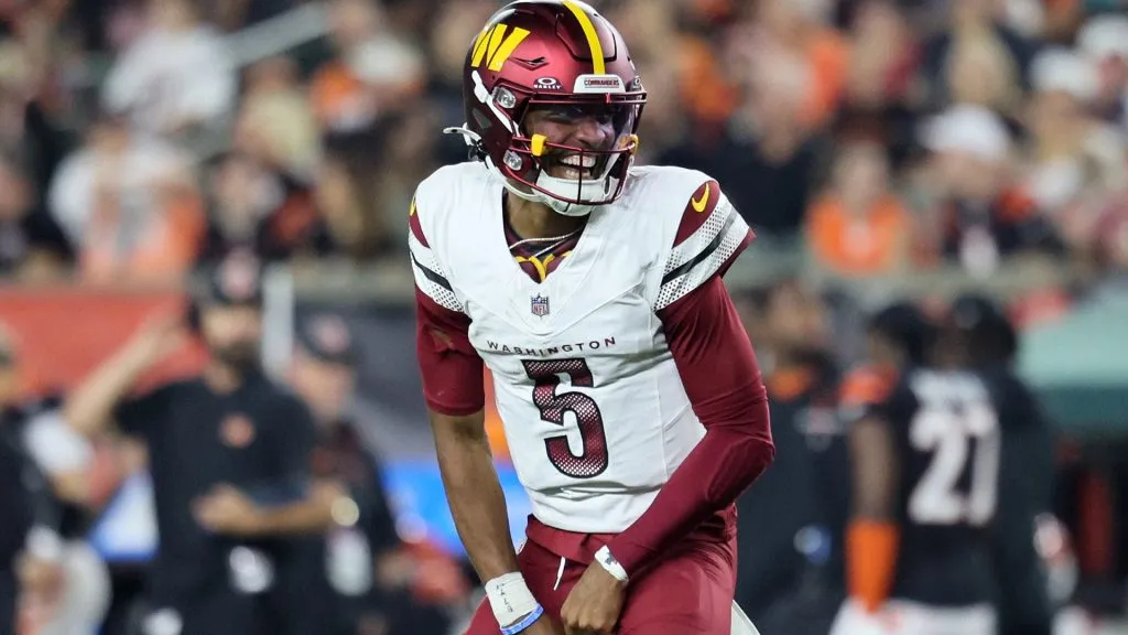 Jayden Daniels #5 of the Washington Commanders celebrates a touchdown scored by Trent Scott #73 against the Cincinnati Bengals during the third quarter at Paycor Stadium on September 23, 2024. (Source: Andy Lyons/Getty Images)