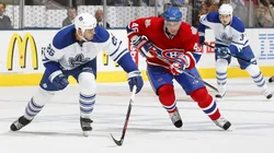 Andrei Kostitsyn #46 of the Montreal Canadiens races for the puck against Mike Van Ryn #26 of the Toronto Maple Leafs during their NHL game on October 11, 2008.
