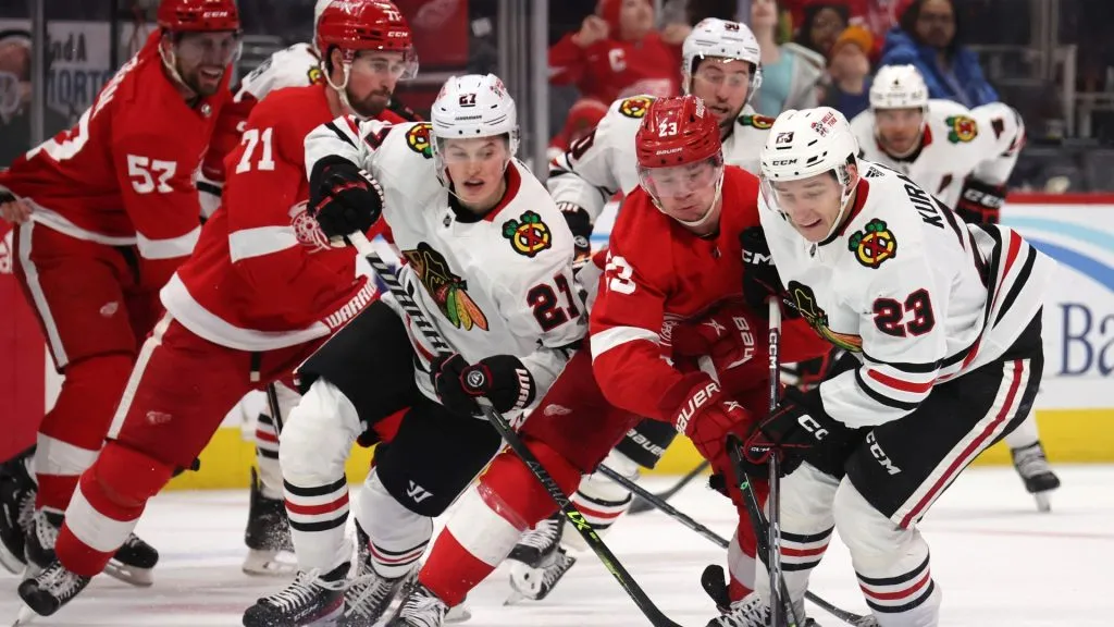 Philipp Kurashev #23 of the Chicago Blackhawks battles for the puck against Lucas Raymond #23 of the Detroit Red Wings during the third period on March 08, 2023. (Source: Gregory Shamus/Getty Images)