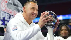 Head coach Steve Sarkisian of the Texas Longhorns lifts the trophy after defeating the Arizona State Sun Devils 39-31 during the second overtime in the Chick-fil-A Peach Bowl at Mercedes-Benz Stadium on January 01, 2025 in Atlanta, Georgia.
