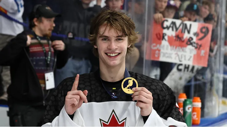 Gavin McKenna celebrates with the gold medal after Canada's 6-4 win vs Team USA during the Gold Medal Game at the IIHF U-18 World Championship.