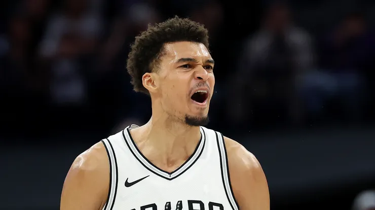 Victor Wembanyama #1 of the San Antonio Spurs reacting in a game.