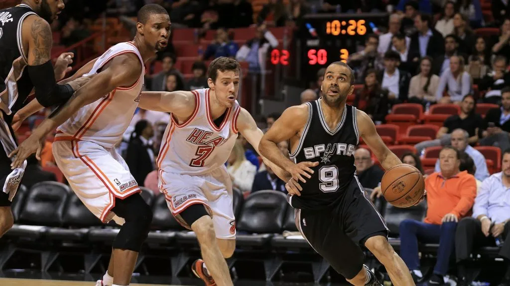 Tony Parker #9 of the San Antonio Spurs drives past Goran Dragic #7 and Chris Bosh #1 of the Miami Heat during a game at American Airlines Arena on February 9, 2016. (Source: Mike Ehrmann/Getty Images)