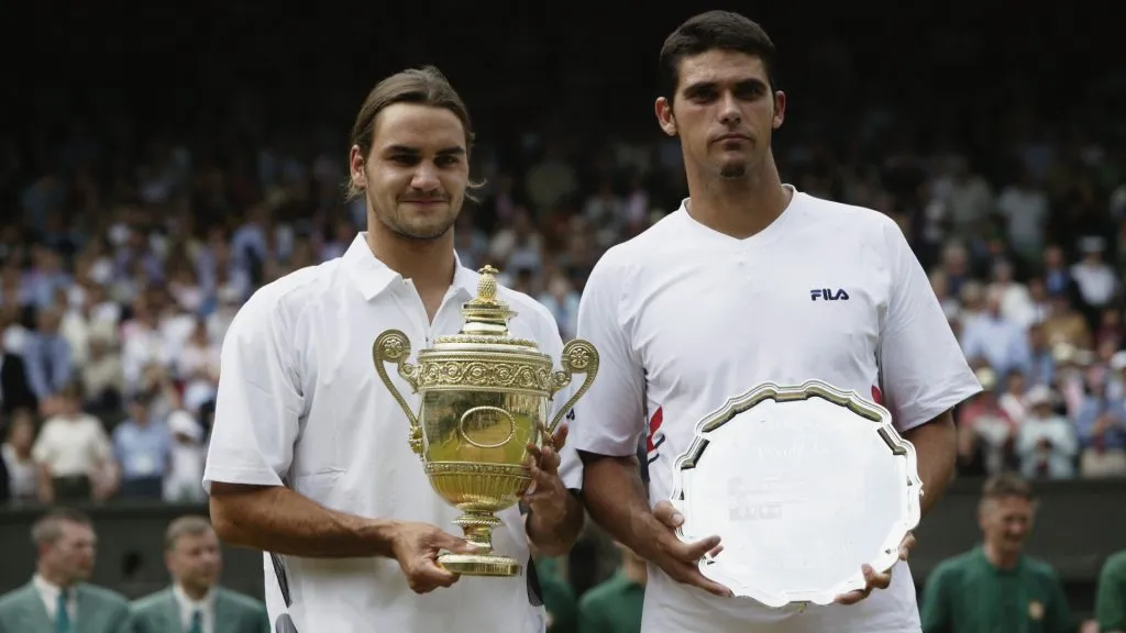 Champion Roger Federer and runner-up Mark Philippoussis with their trophies after the 2003 Wimbledon final. (Alex Livesey/Getty Images)