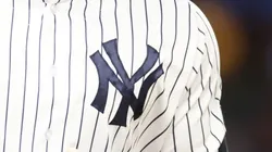 A close-up of Aaron Judge's #99 jersey of the New York Yankees as he points to the dugout after hitting his third home run of the game against the Washington Nationals at Yankee Stadium.
