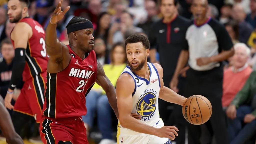Stephen Curry #30 of the Golden State Warriors is guarded by Jimmy Butler #22 of the Miami Heat.