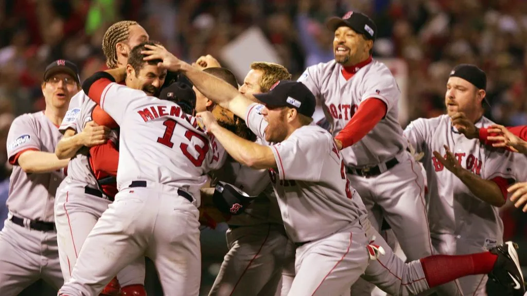 The Boston Red Sox celebrate after defeating the St. Louis Cardinals 3-0 in game four of the World Series on October 27, 2004. (Source: Jed Jacobsohn/Getty Images)