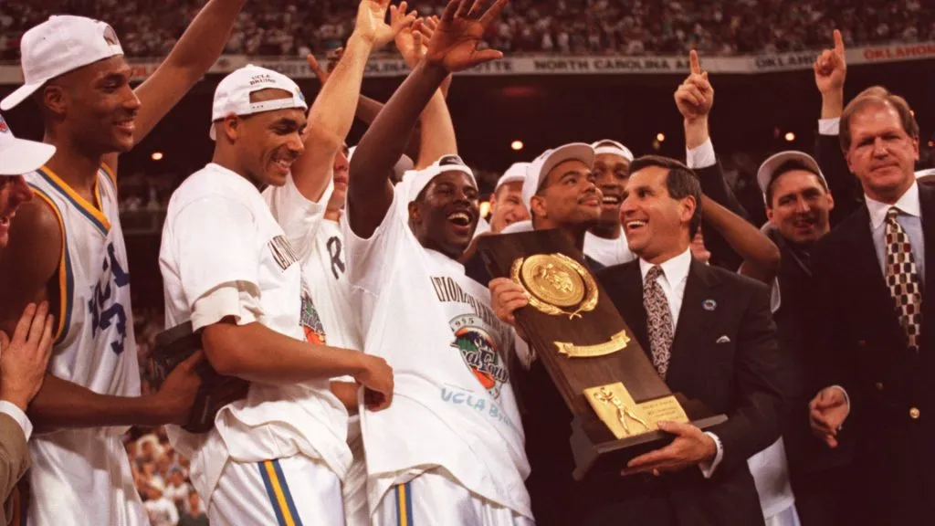 The Ucla Men’s Basketball team celebrates with the championship trophy after defeating Arkansas, 89-78, in the finals at the Kingdome in Seattle in 1995. (Source: Stephen Dunn/ALLSPORT)