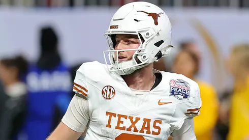 Quinn Ewers #3 of the Texas Longhorns reacts after throwing a pass for a touchdown during the first overtime against the Arizona State Sun Devils in the Chick-fil-A Peach Bowl at Mercedes-Benz Stadium on January 01, 2025 in Atlanta, Georgia.