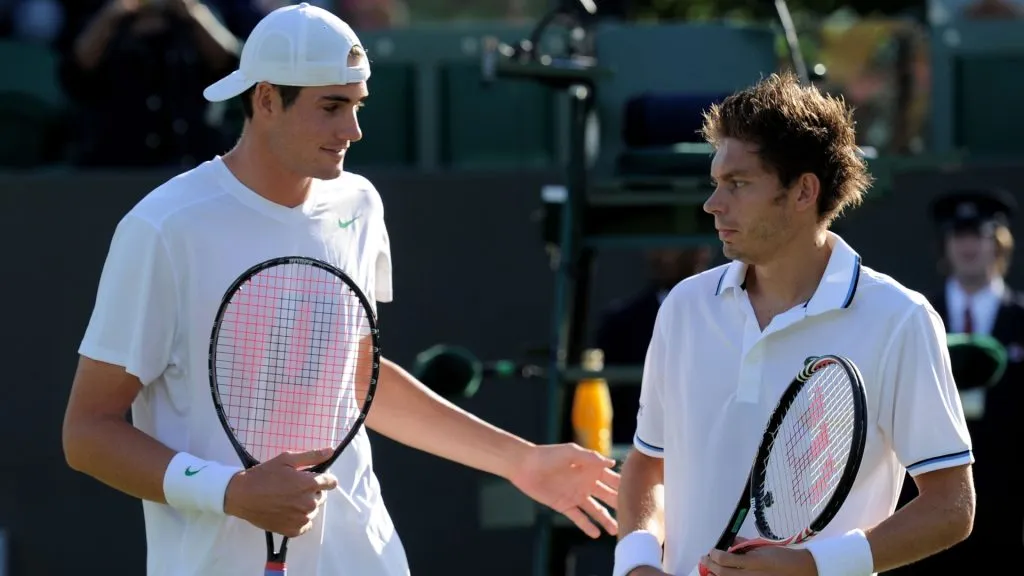 John Isner of the United States (L) and Nicolas Mahut of France meet up at the net before their first round match on Day Two of the Wimbledon Lawn Tennis Championships. (Source: Michael Regan/Getty Images)