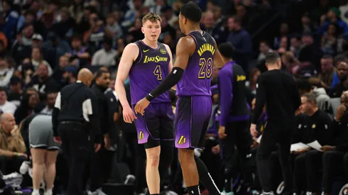 Dalton Knecht #4 of the Los Angeles Lakers talks to Rui Hachimura #28 in the first quarter against the Minnesota Timberwolves.