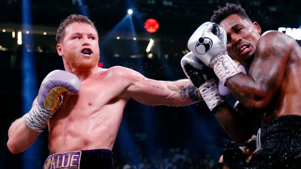 Saul “Canelo” Alvarez of Mexico (purple/gold trunks) trades punches with Jermell Charlo (black trunks) during their super middleweight title fight at T-Mobile Arena on September 30, 2023 in Las Vegas, Nevada. (Photo by Sarah Stier/Getty Images)