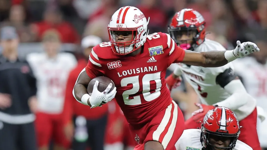 Dre’lyn Washington #20 of the Louisiana-Lafayette Ragin Cajuns runs with the ball as Derek Carter #13 of the Jacksonville State Gamecocks defends during the first half of the R+L Carriers New Orleans Bowl at Caesars Superdome on December 16, 2023 in New Orleans, Louisiana.