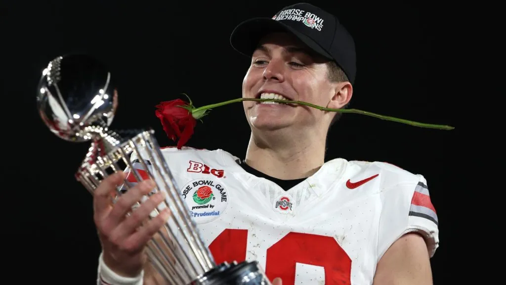 Will Howard holding a trophy