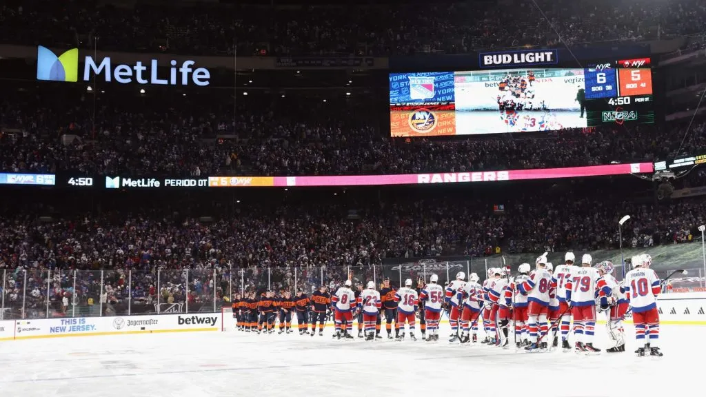 The New York Rangers shake hands with the New York Islanders following the 2024 Navy Federal Credit Union Stadium Series game at MetLife Stadium on February 18, 2024 in East Rutherford, New Jersey.