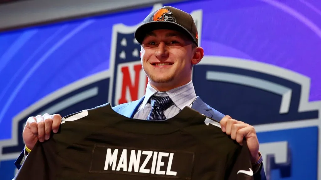 Johnny Manziel of the Texas A&amp;M Aggies poses with a jersey after he was picked #22 overall by the Cleveland Browns during the first round of the 2014 NFL Draft at Radio City Music Hall on May 8, 2014 in New York City.