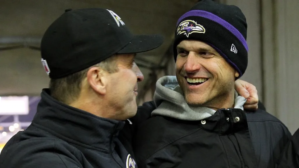 Michigan coach Jim Harbaugh celebrates with his brother, head coach John Harbaugh of the Baltimore Ravens after the Ravens defeated the Pittsburgh Steelers 30-17 in their AFC Wild Card game in 2015. (Source: Jamie Squire/Getty Images)