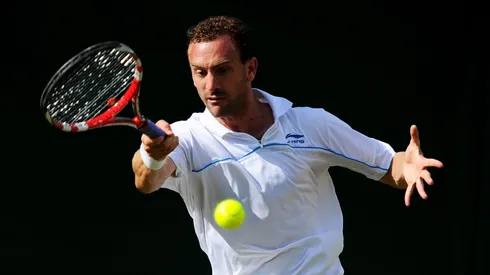 Conor Niland of Ireland returns a shot during his first round match against Adrian Mannarino of France on Day Two of the Wimbledon Lawn Tennis Championships at the All England Lawn Tennis and Croquet Club on June 21, 2011 in London, England.